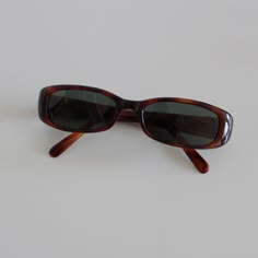 These slim rectangle sunglasses are your everyday classic. Featuring a red tortoise frame with smoke lens. This style is unisex. True genuine vintage sunglasses from the 90s.  - 400 uv  - new vintage from the 90s - includes sunglasses pouch  Measurements: Cheap Rectangular Tortoiseshell Sunglasses, Vintage Sunglasses Outfit, Vintage Sunglasses Aesthetic, Random Accessories, Narrow Sunglasses, 90s Glasses, Autumn 23, 90s Sunglasses, Small Sunglasses