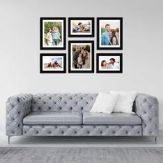 a couch with four pictures hanging on the wall