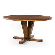 a round wooden table with four legs and a circular wood dining room table in the middle