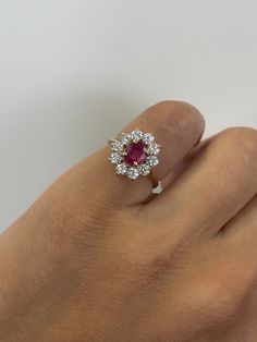 a woman's hand with a diamond and ruby ring