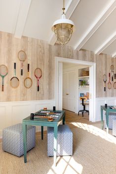 a room with several tennis rackets on the wall