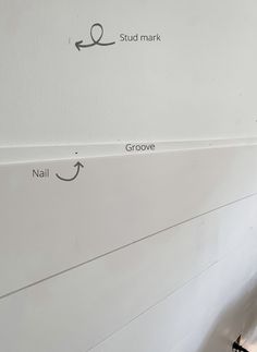 the wall is being painted white and has arrows pointing in different directions to paint it