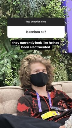 a woman wearing a black face mask sitting on top of a couch next to plants