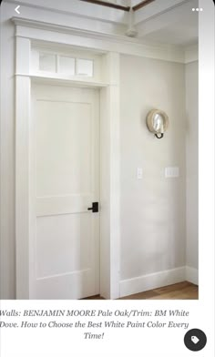 an open door in a room with white walls and wood flooring on the side