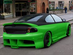 a green sports car parked on the street