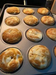 muffins in a pan with white icing on them