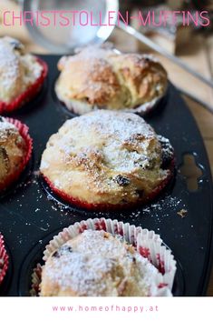 muffins with powdered sugar on top in a baking pan