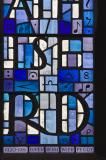 a stained glass window with letters and numbers