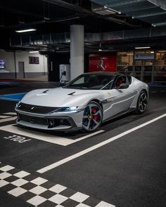 a silver sports car parked in a parking garage