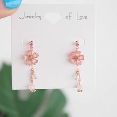 Charming Cherry Blossom Dangle Earrings Add a touch of charm to your outfit with these lovely Charming Cherry Blossom Dangle Earrings. The delicate cherry blossom design is sure to make you stand out and add a playful touch to any look. Perfect for any occasion, these earrings are a beautiful addition to any jewelry collection. Japanese Earrings, Cherry Blossom Earrings, Earrings Japanese, Bridesmaid Gifts Earrings, Kawaii Earrings, Botanical Earrings, Long Gold Earrings, Sakura Flower, Earrings Flower