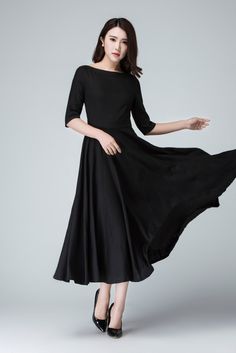 "Create a classic and chic ensemble with this Black maxi dress featuring a fit and flare silhouette . Completed with boat neck linen , three quarter sleeve, it is finished with a hidden Back zipper . This little black dress is perfect for transitioning from the office to an evening in the city . DETAILS * Linen blend * 50% linen , 50% cotton blend * Fitted waist to show off your curves * Boat neckline * Back zipper closure * No pockets * 3/4 sleeve * Midi calf * Wash by hand or machine via cold Linen A-line Evening Dress, Elegant Black Fit And Flare Maxi Dress, Black Fit And Flare Maxi Dress, Elegant Black Midi Dress With Boat Neck, Elegant Black Boat Neck Midi Dress, Elegant Fitted Dress With Wide Hem, Black Boat Neck Dress For Spring, Chic Black Boat Neck Midi Dress, Fitted Linen Midi Dress For Evening