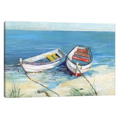 two boats sitting on the beach next to the ocean canvas wall art print, ready to hang