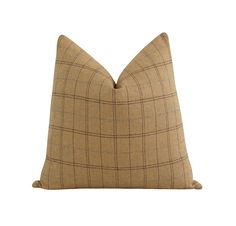 a tan plaid pillow on a white background