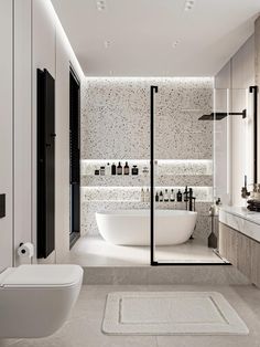 a bathroom with a tub, sink and toilet in it next to a large mirror