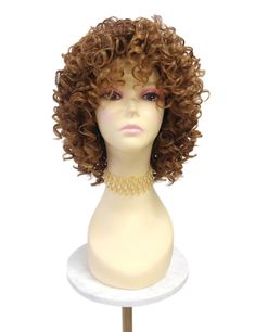 Stylish wig featuring defined spiral curls and bangs. Inside cap has no combs and adjustable elastic straps. Heat-resistant up to 350F. Color:  Strawberry Blonde & Light Auburn Mix with Dark Brown Roots (TT4/2730) Style: 10 inches and Curly. Circumference: Default at 21" with adjustable cap (max 22") Materials: Premium Heat Resistant Synthetic Wig Fiber All sales are final. Please read all store policies before purchasing. Strawberry Blonde Light, Curly Wig With Bangs, Light Auburn, Spiral Curls, Wig With Bangs, Curly Wig, Strawberry Blonde, Curly Wigs, Wigs With Bangs