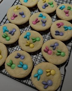 cookies decorated with candies and candy on a cooling rack