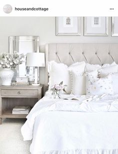 a bed with white sheets and pillows in a bedroom next to two framed pictures on the wall