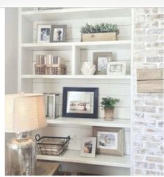 a living room filled with lots of white shelves