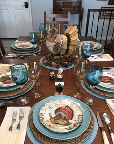 a dinner table set with turkey plates and silverware