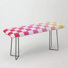 a bench that has a checkered design on the top and bottom, with metal legs