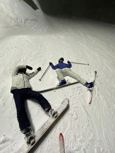 two people on skis in the snow