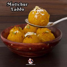 some food is in a bowl with a spoon on it and the words motichur ladoo above it