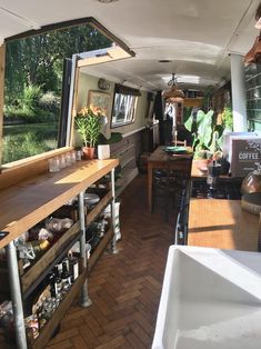 the inside of an rv with lots of storage space and plants on the counter top