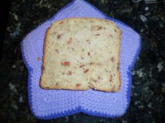 a piece of bread sitting on top of a purple cloth