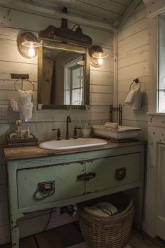 a bathroom with a sink, mirror and basket on the floor in front of it