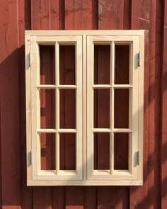 an old window on the side of a red building