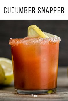 a close up of a drink on a table with lemons