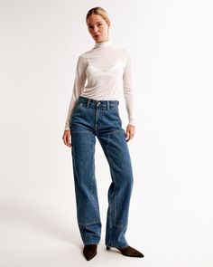 Our new classic mid rise slouchy jeans in a dark wash, with carpenter details and a clean hem. This fit features a 9.5” mid rise, is slouchy at the waist and hips, and eases through the thigh into a baggy, full-length leg shape. We recommend buying your true size for a slouchier fit. Size down for a closer fit. This jean is made from our heavyweight rigid denim, a super soft authentic cotton fabric with no stretch. Slouchy Jeans, Women's Bottoms, Pocket Bag, New Classic, Baggy Jeans, Abercrombie Fitch, Womens Bottoms, Mid Rise, Full Length