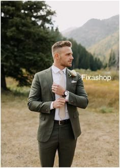 a man wearing a suit and tie standing in the grass