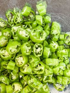 some green peppers are in a bowl on the table and it looks like they have been chopped up