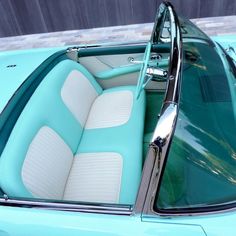 the interior of an old car is blue and white