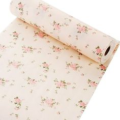 a roll of white paper with pink flowers on it