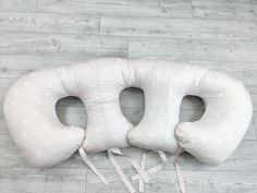 the neck pillow has two ties attached to it's sides and is on top of a wooden floor