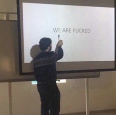 a man standing in front of a projection screen