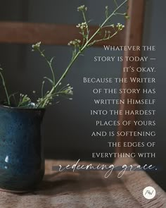 a vase filled with flowers sitting on top of a wooden table next to a quote