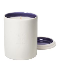 a white and purple candle holder with the words, drink and burnies printed on it