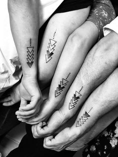 three people with matching tattoos on their feet are holding each other's hands together