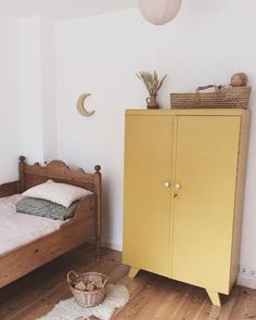 an instagram page with a yellow cabinet and bed