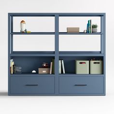 a blue bookcase with two drawers and some books