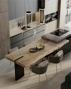 a modern kitchen with an island table and chairs