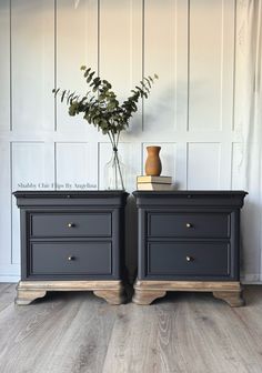 two black nightstands side by side with flowers on top