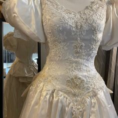 a white wedding dress on display in a store