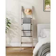 a towel rack in the corner of a bedroom with a hat on top of it