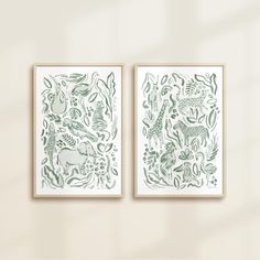 two green and white art prints hanging on a wall next to each other in front of a window