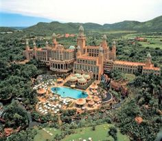 an aerial view of a large building surrounded by trees