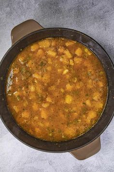 a large pot filled with food sitting on top of a table